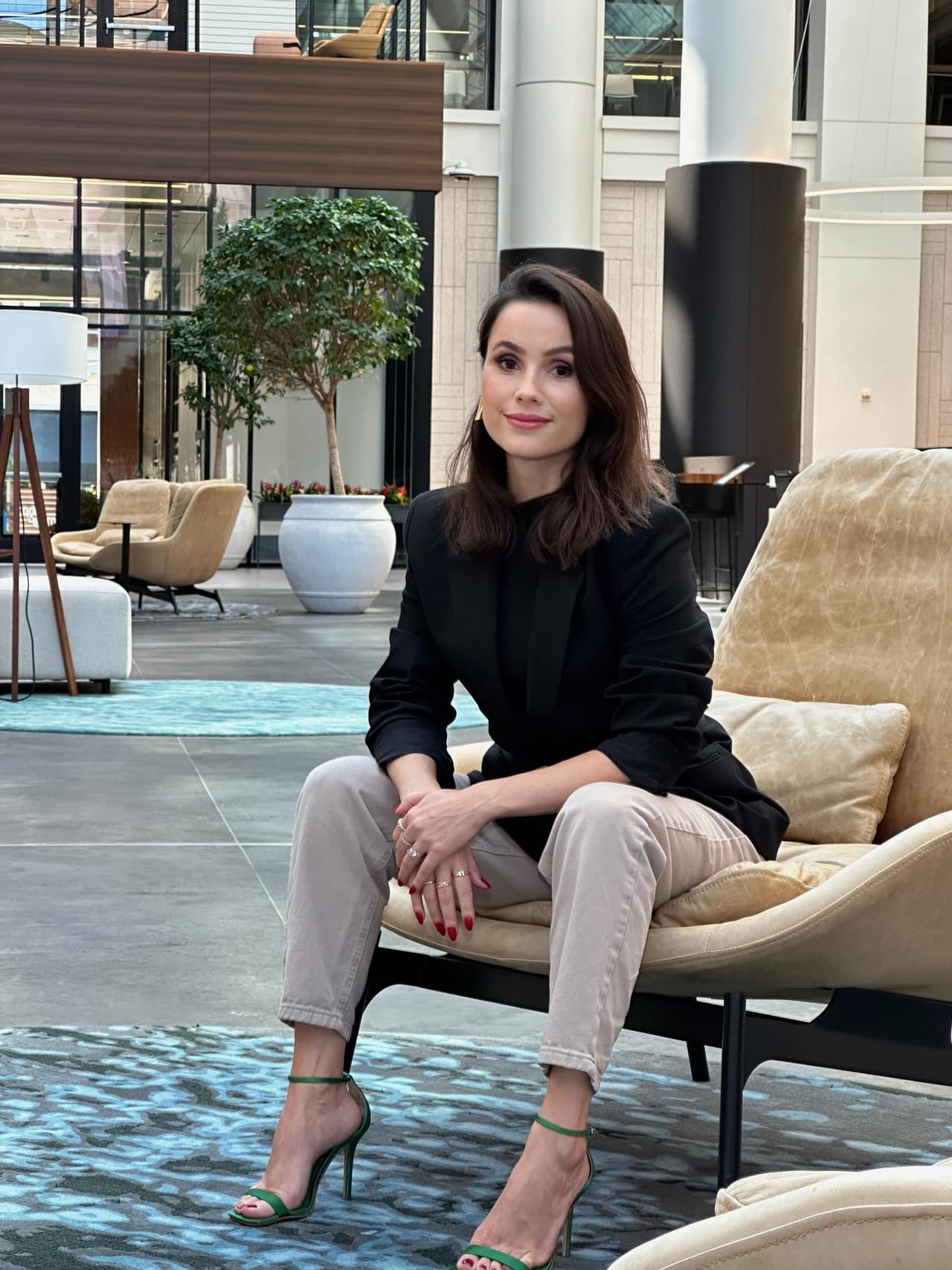 Larissa Peixoto, founder of Studio Black Oak, seated in an Atlanta design showroom.